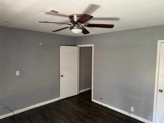 spare room with ceiling fan, baseboards, visible vents, and wood finished floors