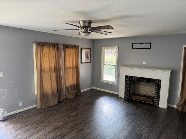 unfurnished living room featuring a fireplace, ceiling fan, baseboards, and wood finished floors