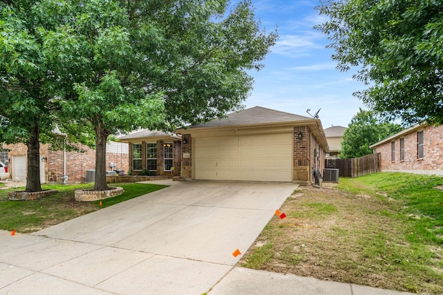 6113 Tilapia Dr, Fort Worth, TX 76179 - view of front of property featuring brick siding, an attached garage, concrete driveway, and central AC