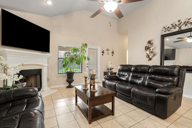 6113 Tilapia Dr, Fort Worth, TX 76179 - living area featuring ceiling fan, light tile patterned floors, a fireplace with raised hearth, and high vaulted ceiling