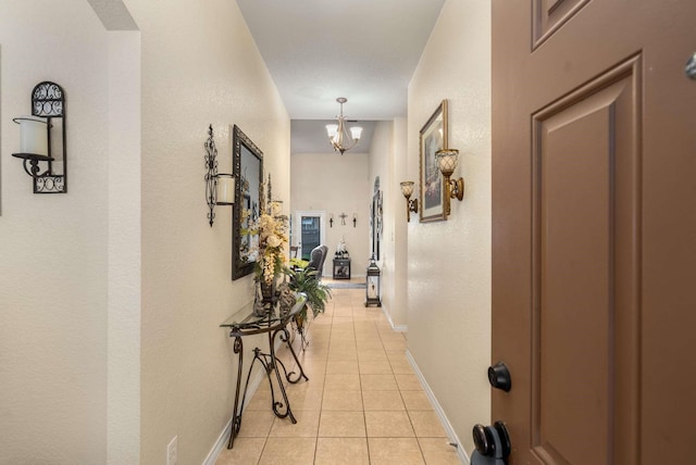 6113 Tilapia Dr, Fort Worth, TX 76179 - hallway with light tile patterned floors, a chandelier, and baseboards