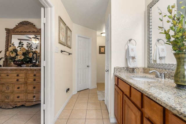 6113 Tilapia Dr, Fort Worth, TX 76179 - bathroom with tile patterned floors, vanity, baseboards, and a textured ceiling