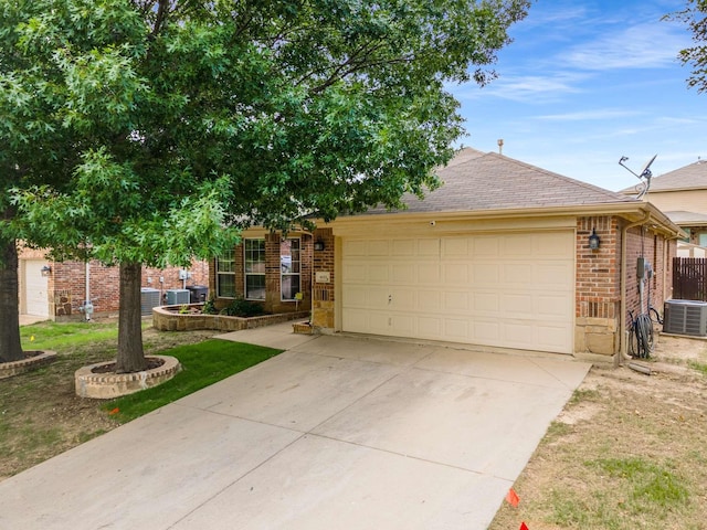 6113 Tilapia Dr, Fort Worth, TX 76179 - view of front of property featuring an attached garage, central AC unit, concrete driveway, brick siding, and roof with shingles
