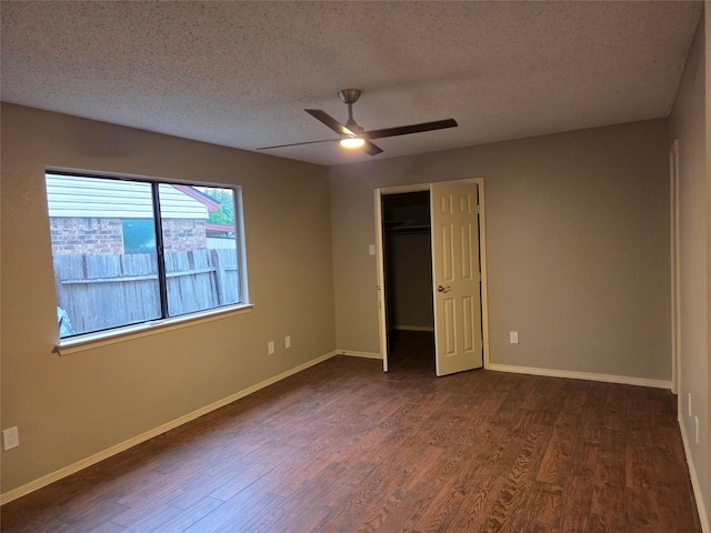 2149 Pueblo Dr, Garland, TX 75040 - unfurnished bedroom with baseboards, dark wood-style flooring, a closet, and a textured ceiling