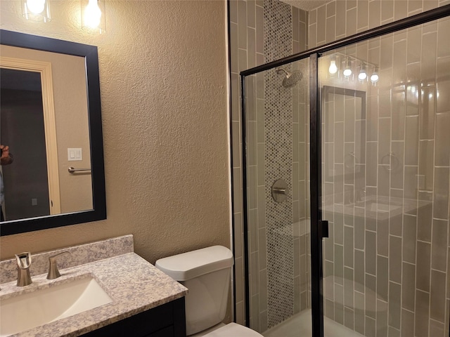 2149 Pueblo Dr, Garland, TX 75040 - bathroom with a shower stall, vanity, toilet, and a textured wall