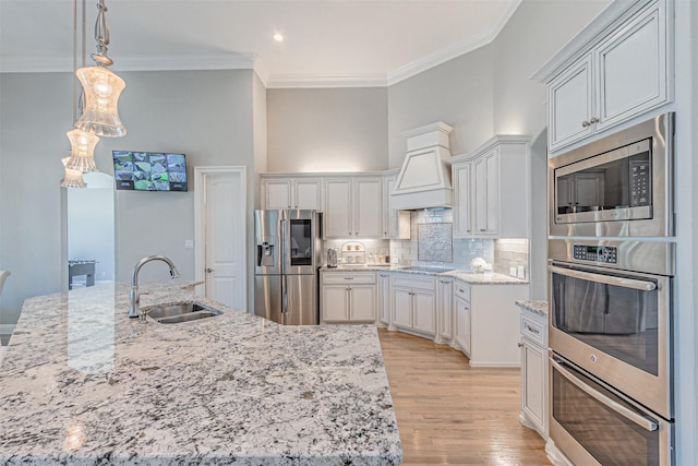 621 E Fm 550, Mclendon Chisholm, TX 75032 - kitchen with a sink, stainless steel appliances, light stone counters, crown molding, and light wood-style flooring