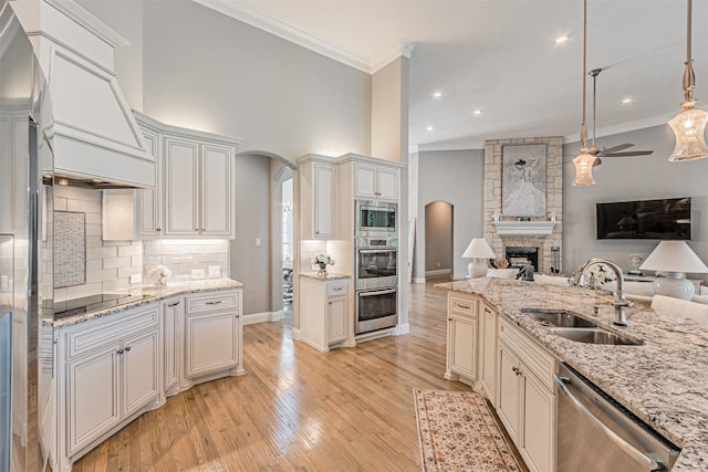 621 E Fm 550, Mclendon Chisholm, TX 75032 - kitchen featuring ornamental molding, a sink, open floor plan, arched walkways, and stainless steel appliances