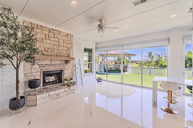 621 E Fm 550, Mclendon Chisholm, TX 75032 - unfurnished living room featuring a fireplace, ceiling fan, plenty of natural light, and visible vents