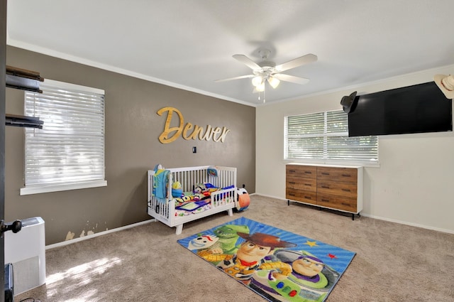 1601 E Bankhead Dr, Weatherford, TX 76086 - carpeted bedroom featuring crown molding, a nursery area, ceiling fan, and baseboards