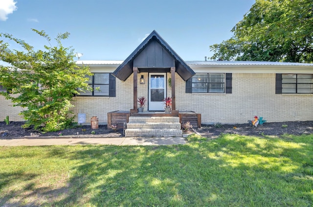 1601 E Bankhead Dr, Weatherford, TX 76086 - view of front of house with brick siding, a front lawn, and metal roof