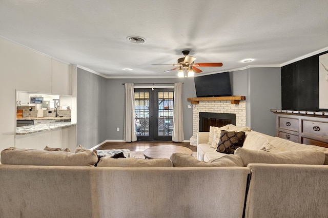 1601 E Bankhead Dr, Weatherford, TX 76086 - living room featuring crown molding, a ceiling fan, baseboards, wood finished floors, and a fireplace