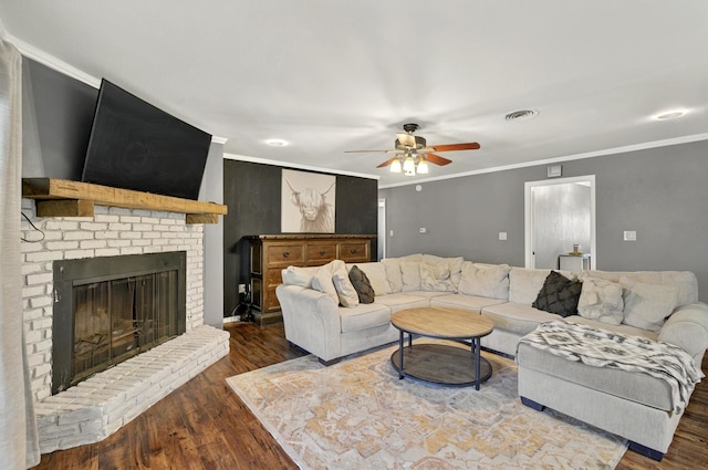 1601 E Bankhead Dr, Weatherford, TX 76086 - living room with ceiling fan, dark wood-style flooring, crown molding, and a brick fireplace