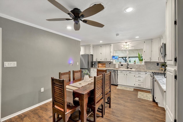 1601 E Bankhead Dr, Weatherford, TX 76086 - dining room featuring a ceiling fan, dark wood-style floors, crown molding, recessed lighting, and baseboards