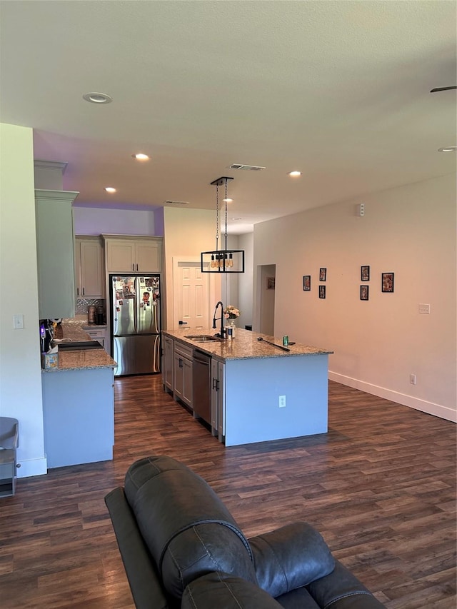 2631 Fish Tank Rd, Corsicana, TX 75110 - kitchen with stainless steel appliances, a sink, dark wood-style floors, light stone countertops, and pendant lighting
