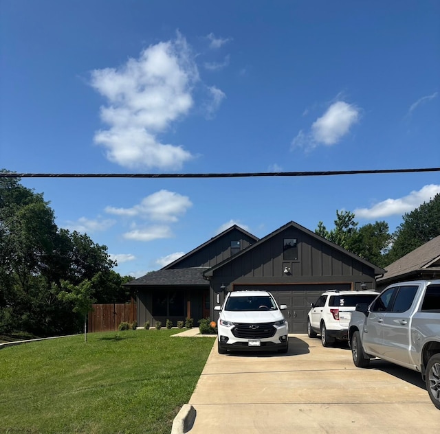 2631 Fish Tank Rd, Corsicana, TX 75110 - view of front of property with board and batten siding, concrete driveway, and a garage