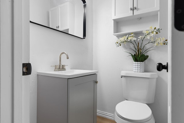 2617 Fordham Rd, Dallas, TX 75216 - half bathroom with toilet, vanity, and wood finished floors