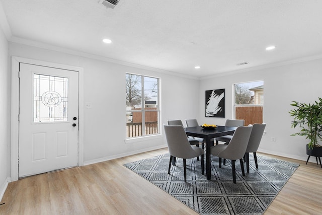 2617 Fordham Rd, Dallas, TX 75216 - dining area with baseboards, ornamental molding, visible vents, and wood finished floors