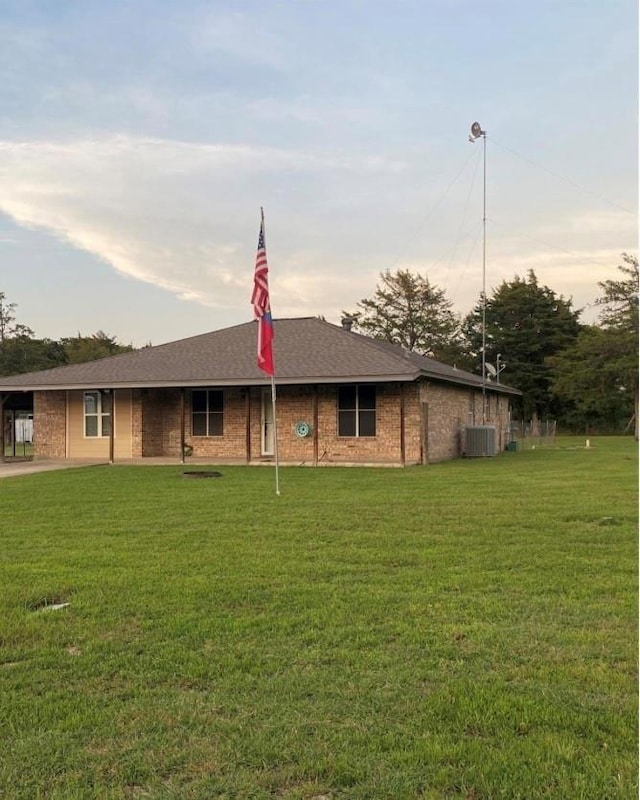 204 County Road 2211, Ivanhoe, TX 75447 - view of front of house with cooling unit, brick siding, a shingled roof, and a front yard