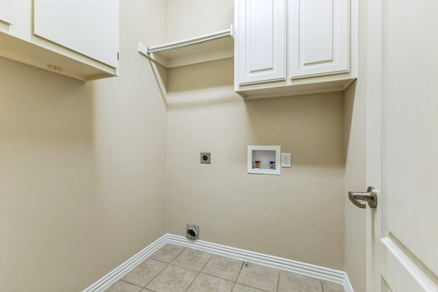 laundry area featuring hookup for an electric dryer, cabinet space, baseboards, washer hookup, and light tile patterned flooring