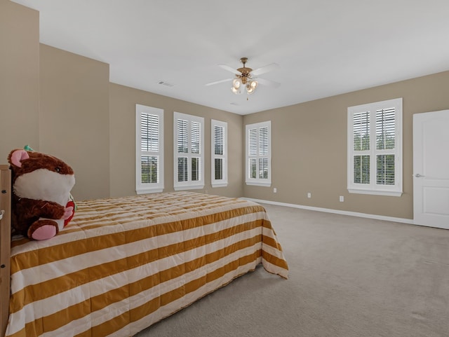 carpeted bedroom with baseboards and ceiling fan