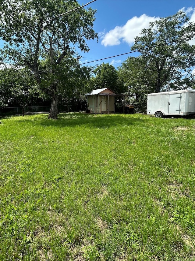 3819 N Terry St, Fort Worth, TX 76106 - view of grassy yard with a storage shed and an outbuilding