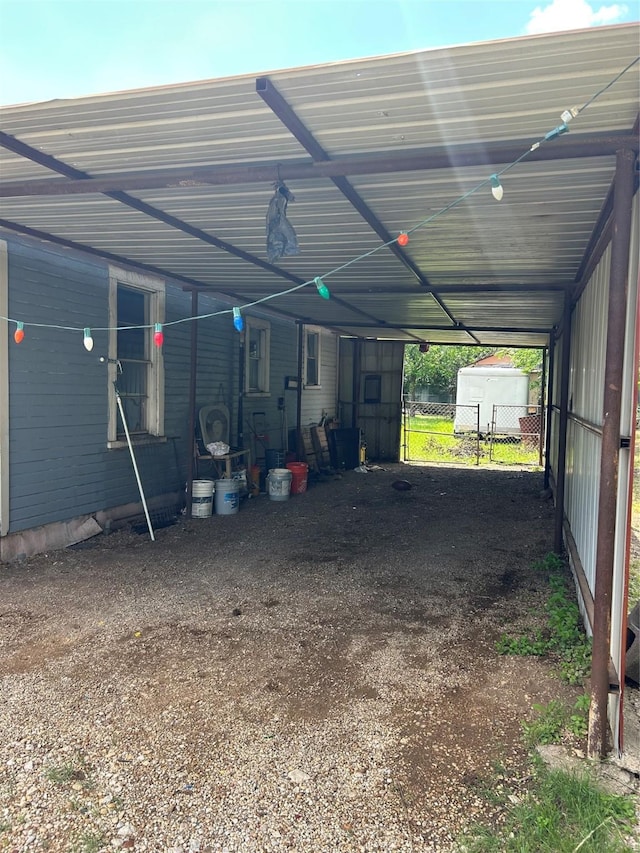 3819 N Terry St, Fort Worth, TX 76106 - garage featuring an attached carport, fence, and a shed
