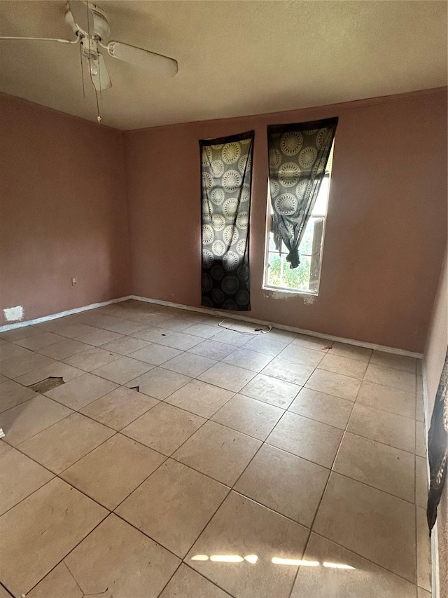 3819 N Terry St, Fort Worth, TX 76106 - tiled empty room with a ceiling fan and baseboards