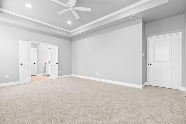 120 Water View Ln, Robinson, TX 76706 - unfurnished bedroom with a tray ceiling, baseboards, ornamental molding, visible vents, and light carpet