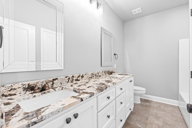 120 Water View Ln, Robinson, TX 76706 - bathroom with a sink, toilet, double vanity, baseboards, and a bath