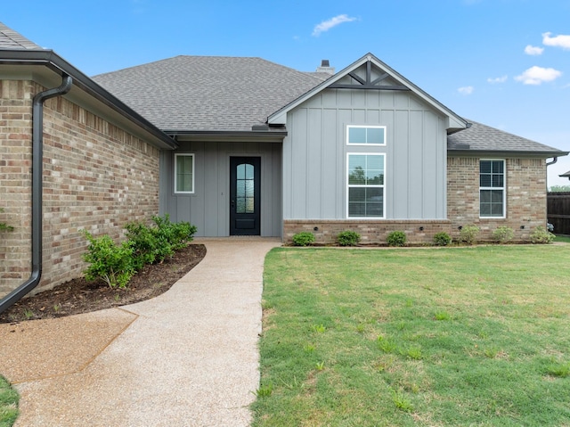 120 Water View Ln, Robinson, TX 76706 - view of front facade with a front yard, a shingled roof, brick siding, and board and batten siding