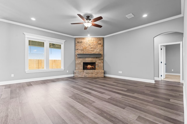 120 Water View Ln, Robinson, TX 76706 - unfurnished living room with a ceiling fan, a fireplace, visible vents, dark wood-style flooring, and arched walkways