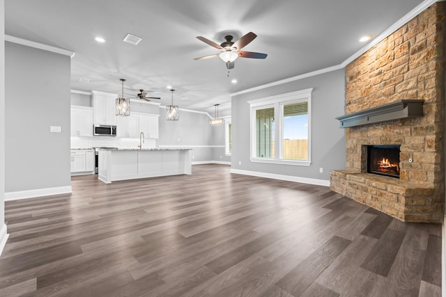 120 Water View Ln, Robinson, TX 76706 - unfurnished living room featuring a fireplace, ceiling fan with notable chandelier, and recessed lighting