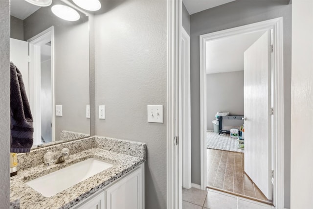 3600 Riesling Dr, Denton, TX 76226 - bathroom with baseboards, tile patterned flooring, and vanity