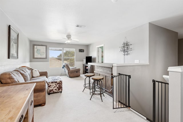 3600 Riesling Dr, Denton, TX 76226 - living room with a ceiling fan, light carpet, wainscoting, and visible vents