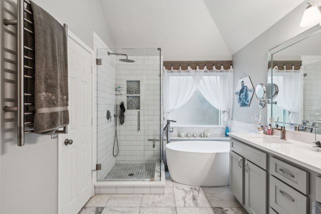 7204 Vanderbilt Dr, Mckinney, TX 75072 - bathroom with lofted ceiling, radiator heating unit, a stall shower, a freestanding tub, and double vanity