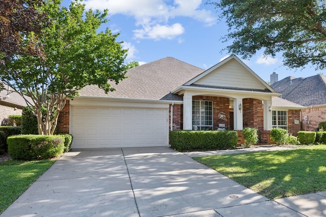 7204 Vanderbilt Dr, Mckinney, TX 75072 - view of front of home with a garage, brick siding, driveway, and a front lawn
