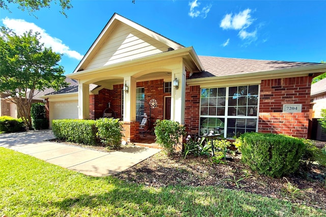 7204 Vanderbilt Dr, Mckinney, TX 75072 - view of front of home with brick siding, an attached garage, driveway, roof with shingles, and a porch