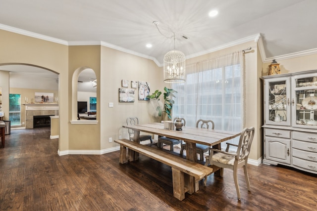 7204 Vanderbilt Dr, Mckinney, TX 75072 - dining area with dark wood-style flooring, healthy amount of natural light, crown molding, baseboards, and arched walkways