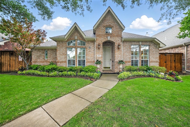 3861 Navarro Way, Frisco, TX 75034 - tudor house with a front yard, brick siding, and fence