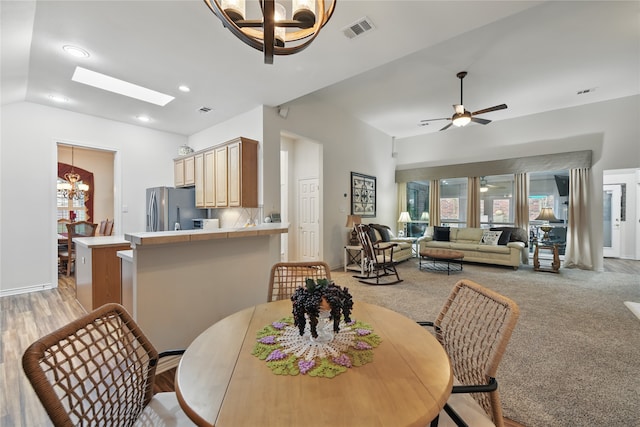 3861 Navarro Way, Frisco, TX 75034 - dining area with vaulted ceiling, light carpet, ceiling fan with notable chandelier, and visible vents