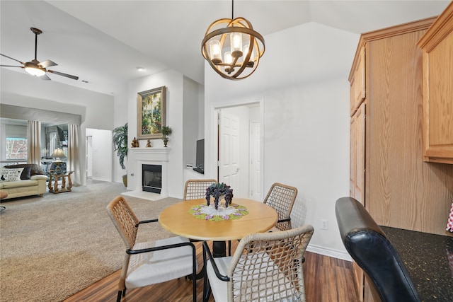 3861 Navarro Way, Frisco, TX 75034 - dining space featuring baseboards, ceiling fan with notable chandelier, a fireplace with flush hearth, and lofted ceiling