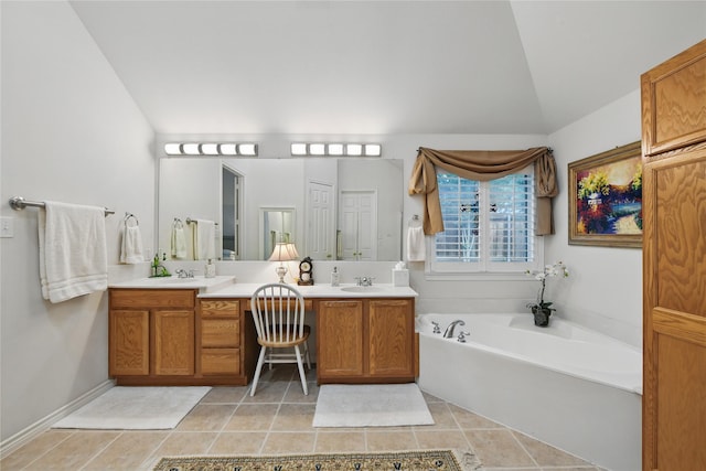 3861 Navarro Way, Frisco, TX 75034 - bathroom featuring a sink, double vanity, a garden tub, and tile patterned flooring