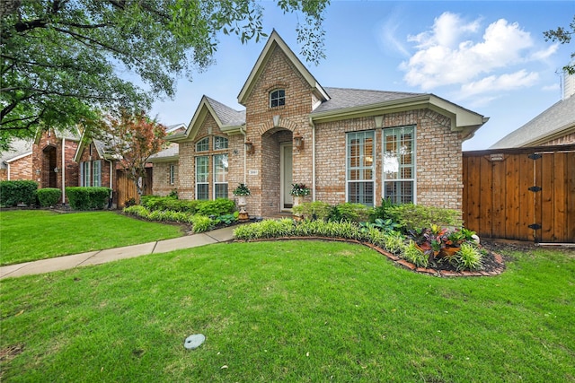 3861 Navarro Way, Frisco, TX 75034 - tudor home with roof with shingles, brick siding, and a front yard