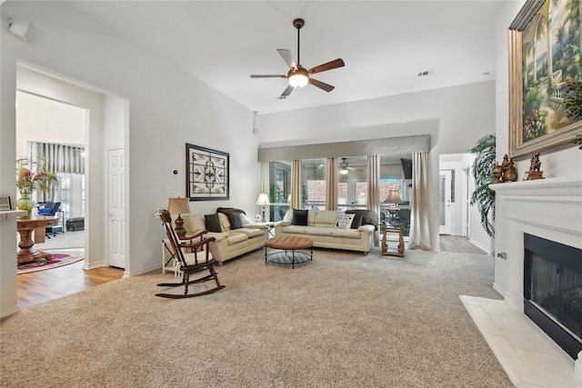3861 Navarro Way, Frisco, TX 75034 - living room with a fireplace with flush hearth, light colored carpet, a ceiling fan, and visible vents
