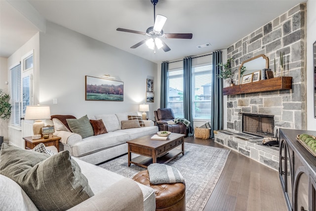2009 Gill Star Dr, Haslet, TX 76052 - living area featuring a ceiling fan, a stone fireplace, visible vents, and wood finished floors