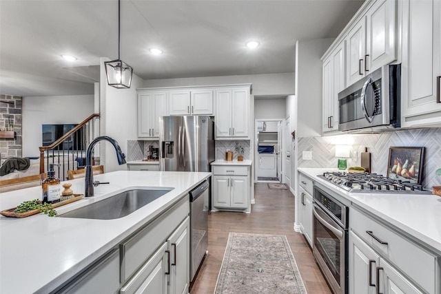 2009 Gill Star Dr, Haslet, TX 76052 - kitchen with a sink, pendant lighting, light countertops, appliances with stainless steel finishes, and tasteful backsplash