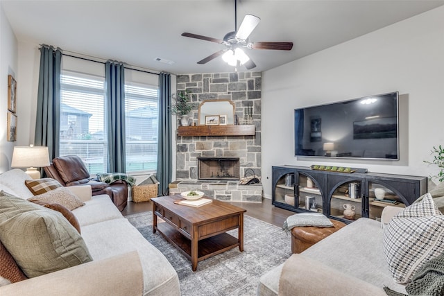 2009 Gill Star Dr, Haslet, TX 76052 - living area featuring a stone fireplace, visible vents, ceiling fan, and wood finished floors