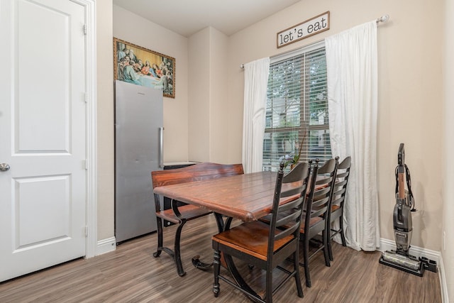 dining area with wood finished floors and baseboards
