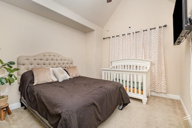 bedroom with carpet floors, vaulted ceiling, and baseboards