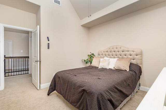 carpeted bedroom with baseboards and vaulted ceiling